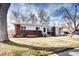 Charming brick home with a well-manicured lawn, inviting curb appeal, and mature trees in a desirable neighborhood at 6737 Lee St, Arvada, CO 80004