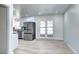 Modern kitchen with stainless steel appliances, white cabinetry and eat-in area bathed in natural light at 6737 Lee St, Arvada, CO 80004