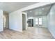 Bright living room with open access to kitchen, sleek vinyl flooring, and freshly painted white walls at 6737 Lee St, Arvada, CO 80004