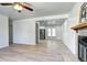 Open-concept living space featuring a fireplace and seamless flow to the adjacent kitchen, creating a great entertaining space at 6737 Lee St, Arvada, CO 80004