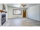 Inviting living room with fireplace, wooden door and a large window offering a view of the outdoors at 6737 Lee St, Arvada, CO 80004