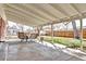 Covered patio with outdoor dining set and view of the backyard at 6737 Lee St, Arvada, CO 80004