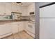 White kitchen with appliances and ample counter space at 2500 S York St # 107, Denver, CO 80210