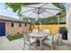 Inviting back patio with ample seating, a large umbrella, a patio heater, and an outdoor kitchen area at 1511 S Pennsylvania St, Denver, CO 80210