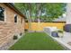 Serene backyard showcasing an artificial lawn, lush landscaping, and a modern outdoor living space at 1511 S Pennsylvania St, Denver, CO 80210