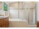 Bright bathroom featuring double vanity, soaking tub, and glass shower at 1511 S Pennsylvania St, Denver, CO 80210