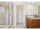 Bright bathroom with glass shower, wood cabinets, and sink at 1511 S Pennsylvania St, Denver, CO 80210