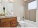Modern bathroom features a vessel sink, wood vanity, tile surround, and a soaking tub with shower at 1511 S Pennsylvania St, Denver, CO 80210