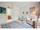 Bedroom featuring a crib, comfortable chair, and stylish decor at 1511 S Pennsylvania St, Denver, CO 80210