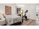 Bedroom featuring hardwood floors, a large window with natural light and exercise equipment at 1511 S Pennsylvania St, Denver, CO 80210