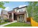 Contemporary home featuring stone accents, a covered entryway, and well-maintained landscaping at 1511 S Pennsylvania St, Denver, CO 80210