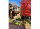 Charming two-story home with manicured front yard, mature trees and a decorative fence at 1511 S Pennsylvania St, Denver, CO 80210