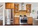 Updated kitchen featuring wood cabinets, stainless steel appliances, quartz countertops, and beautiful tile backsplash at 1511 S Pennsylvania St, Denver, CO 80210