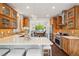 Bright kitchen boasts wood cabinetry, mosaic backsplash, stainless steel appliances and an open layout to the dining room at 1511 S Pennsylvania St, Denver, CO 80210