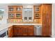 Updated kitchen featuring wood cabinets, stainless steel dishwasher, quartz countertops, and beautiful tile backsplash at 1511 S Pennsylvania St, Denver, CO 80210