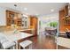 Bright kitchen boasts wood cabinetry, mosaic backsplash, stainless steel appliances and an open layout to the dining room at 1511 S Pennsylvania St, Denver, CO 80210