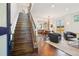 Open concept living room featuring wood staircase, hardwood floors, and modern decor at 1511 S Pennsylvania St, Denver, CO 80210