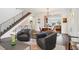 Open concept living and dining area with hardwood floors, modern lighting, and staircase at 1511 S Pennsylvania St, Denver, CO 80210