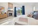 Bright main bedroom featuring a fireplace, television, and view at 1511 S Pennsylvania St, Denver, CO 80210