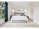 Bright main bedroom with a large window, two side tables, and stylish decor at 1511 S Pennsylvania St, Denver, CO 80210