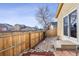 Fenced backyard features a brick pathway, rock garden and view of neighboring homes at 10121 Wyandott Cir, Thornton, CO 80260