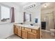 Bathroom featuring a large double sink vanity and a shower-tub combo at 10121 Wyandott Cir, Thornton, CO 80260