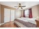 Bedroom with wood floors, ceiling fan and double door closet at 10121 Wyandott Cir, Thornton, CO 80260