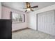 Neutral bedroom featuring a ceiling fan, large window, and closet at 10121 Wyandott Cir, Thornton, CO 80260