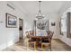 Elegant dining room with hardwood floors, a modern chandelier, and large windows at 10121 Wyandott Cir, Thornton, CO 80260