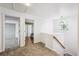 Upstairs hallway features carpet, wood railing, and a stained glass window at 10121 Wyandott Cir, Thornton, CO 80260