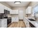 Modern kitchen with stainless steel appliances, granite countertops, and white cabinets at 10121 Wyandott Cir, Thornton, CO 80260