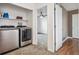 Laundry room with side by side washer and dryer units and overhead shelving at 10121 Wyandott Cir, Thornton, CO 80260