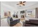 Inviting living room featuring a cozy fireplace, sleek hardwood floors, and plenty of natural light at 10121 Wyandott Cir, Thornton, CO 80260