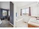 Bright primary bath featuring a soaking tub, large window and double sinks at 10121 Wyandott Cir, Thornton, CO 80260