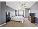 Large primary bedroom with sitting area, ceiling fan and neutral carpet at 10121 Wyandott Cir, Thornton, CO 80260