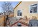 Cozy patio area with brick pavers, seating and a charming rock garden with mature landscaping at 10121 Wyandott Cir, Thornton, CO 80260
