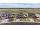 Aerial view of a suburban home with a large field and mountain views in the background at 11741 Magnolia St, Thornton, CO 80233