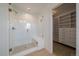 Modern bathroom featuring a glass-enclosed shower and custom walk-in closet at 11741 Magnolia St, Thornton, CO 80233