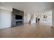 Spacious living area with modern fireplace and open floor plan to the kitchen at 11741 Magnolia St, Thornton, CO 80233