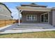 Cozy covered patio with steps leading down to the well-maintained backyard at 11741 Magnolia St, Thornton, CO 80233