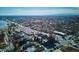 Wide aerial shot of a neighborhood, highlighting streets and buildings, with mountains in the distance on a bright, sunny day at 5128 W 26Th Ave # 311, Denver, CO 80212