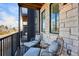 Relaxing balcony features stone siding, black trim windows and railing, with seating perfect for enjoying views at 5128 W 26Th Ave # 311, Denver, CO 80212