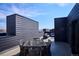 Relaxing rooftop patio with stylish wicker furniture and stunning city views for outdoor entertaining at 5128 W 26Th Ave # 311, Denver, CO 80212