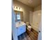 Bright bathroom includes a shower and tub combination, wood look flooring, and large vanity at 8428 Galvani Trl # D, Littleton, CO 80129