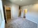 Neutral bedroom features gray carpet, closet and bathroom access for optimal convenience at 8428 Galvani Trl # D, Littleton, CO 80129