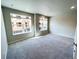 Spacious bedroom features light gray walls, plush carpet, and natural light through many windows at 8428 Galvani Trl # D, Littleton, CO 80129
