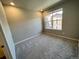 Cozy bedroom with carpet, neutral paint, and a window with a view at 8428 Galvani Trl # D, Littleton, CO 80129
