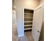 Open closet features neutral walls and multiple shelves for maximum storage potential at 8428 Galvani Trl # D, Littleton, CO 80129