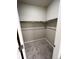 Walk-in closet includes hanging racks and plush gray carpet for comfortable storage at 8428 Galvani Trl # D, Littleton, CO 80129