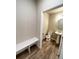 Half bathroom with pedestal sink, wood-look floors, and a bench at 8428 Galvani Trl # D, Littleton, CO 80129